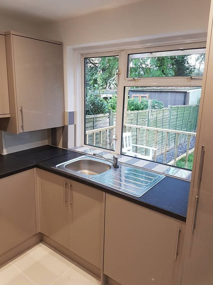 Kitchen sink, taps and waste installed under a window