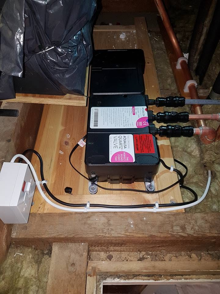 Aqualisa shower pump and valve installed in a loft space